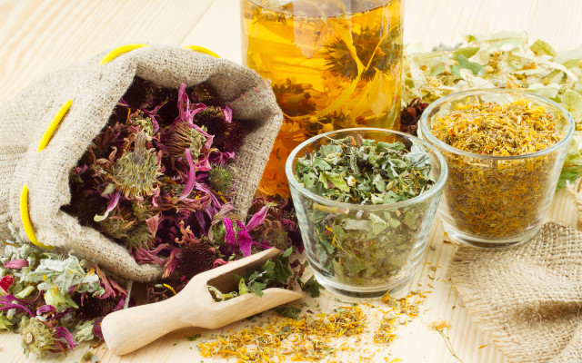 healing herbs and healthy tea on wooden table, herbal medicine Some herbs and spices are thought to have healing powers.