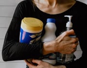 woman holding disinfectant